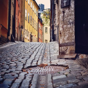 Sweden, Svealand, Stockholm,  Manhole cover in cobbled street