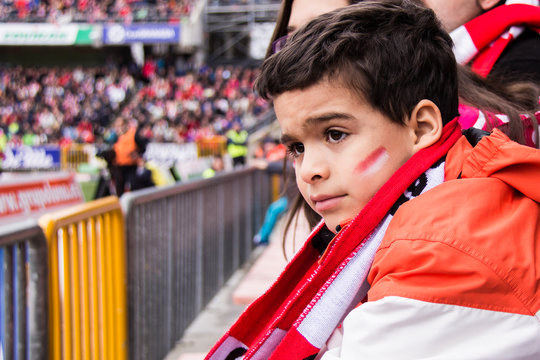 Side view of boy watching football match