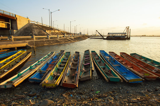 Philippines, Ilocos Region, Pangasinan, Dagupan, Colorful boats by water's edge