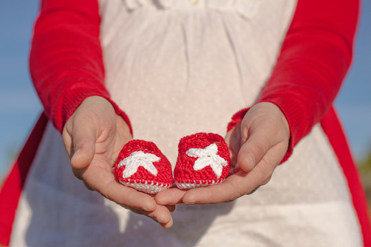 Spain, Provincia de Guadalajara, Castilla-La Mancha, Girl holding baby shoes