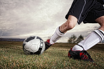 USA, Colorado, Boy kicking soccer ball