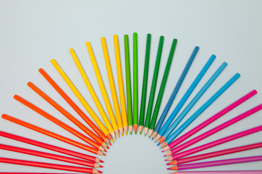 Overhead view of Assorted Coloured Pencils arranged in a semi circle