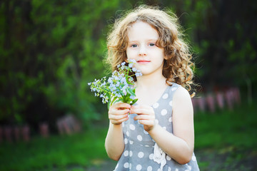 Happy girl with a flower in her hand. Mothers day concept.