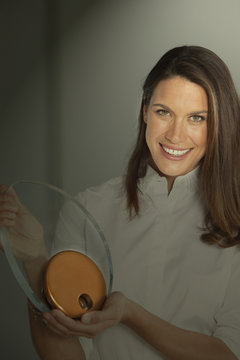 Business woman with award, in spotlight