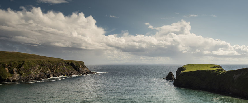 Ireland, County Donegal, Glencolmcille, Malin Beag, View of green cliffs on sea