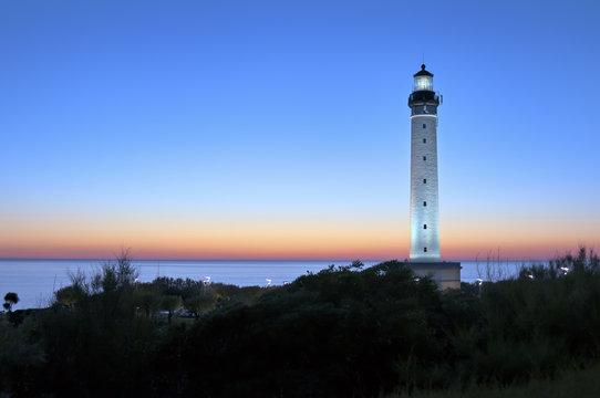 Spain, Castille-La Manche, Provincia de Guadalajara, Uceda, Caraquiz, Calle Biarriz, Illuminated Phare de Biarritz against clear sky at dusk