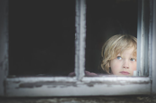 Portrait Of Young Boy (6-7) Behind Window