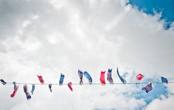 Japan, Okinawa, Children's day koi flags against clouds