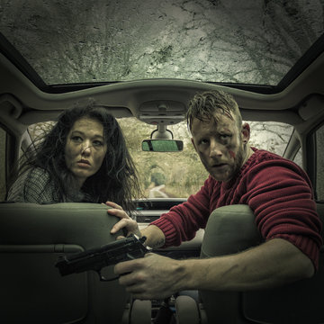 Man and woman in car with handgun