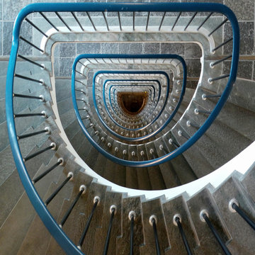 Overhead view of a spiral staircase with blue metal railings 