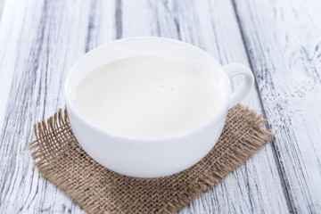 Milk on bright wooden background