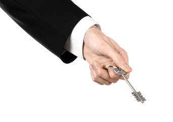 real estate agent in his hand the key to a new apartment