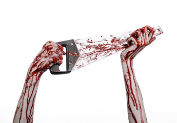bloody hand holding a bloody saw on a white background