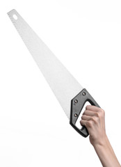 hand holding a saw with a black pen white background isolated