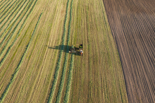 aerial view of harvest fields with combine and tractor