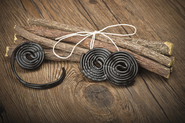 Licorice wheels candies close up on the wood