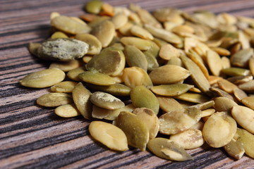 Pumpkin seeds on wooden background