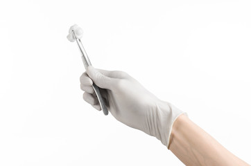 doctor's hand in a glove holding tweezers with swab isolated