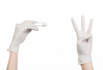 doctor's hand in a glove holding tweezers with swab isolated 