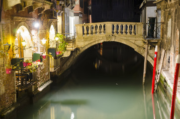 Fototapeta na wymiar Venice cityscape, narrow water canal and bridge at night, Italy