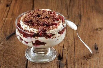 Rye bread tiramisu with cherries, chocolate and silver spoon on
