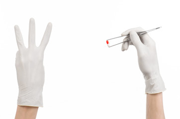 doctor's hand holding tweezers with red pill capsule isolated 