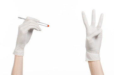doctor's hand holding tweezers with red pill capsule isolated