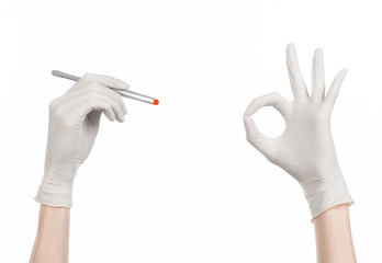 doctor's hand holding tweezers with red pill capsule isolated