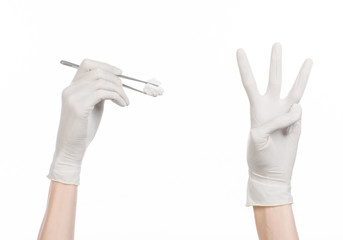 doctor's hand holding tweezers with swab isolated studio