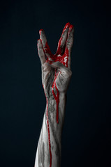 horrible zombie demon bloody hands on a black background