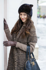 Young beautiful woman in stylish mink coat
