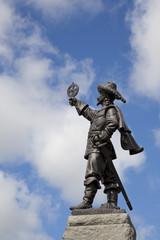 statue of Samuel de Champlain holding astrolabe
