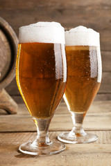 Glasses of beer on wooden background