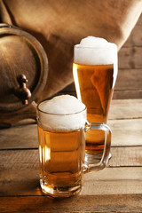 Glasses of beer on wooden background