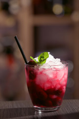 Glass of cocktail on bar background