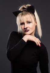 young beautiful woman dressed as cuddly cat makes gestures