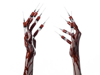Bloody hand with syringe on the fingers, toes syringes in studio
