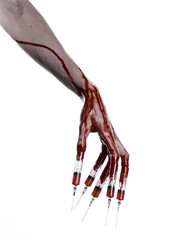 Bloody hand with syringe on the fingers, toes syringes in studio