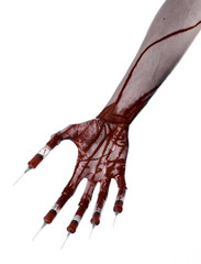 Bloody hand with syringe on the fingers, toes syringes in studio