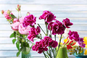 Fototapeta na wymiar Different beautiful flowers in vases close up