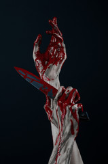 Obraz na płótnie Canvas zombie killer holding a large bloody knife isolated in studio