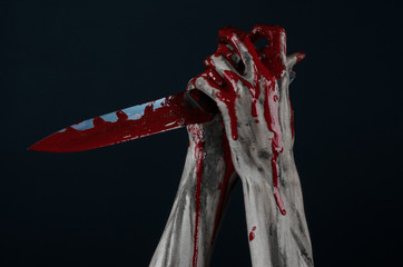 zombie killer holding a large bloody knife isolated  in studio