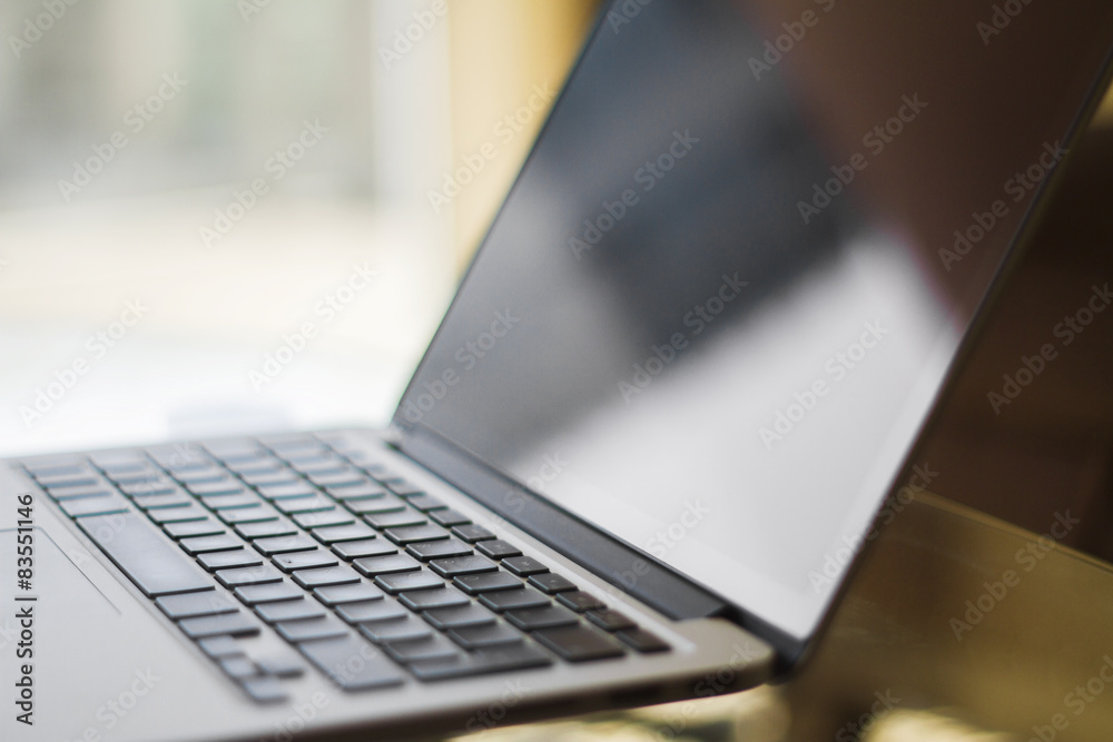 Poster laptop on a table at home, shallow depth of field
