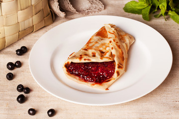 appetizing meal pancakes with raspberry jam in a rustic still