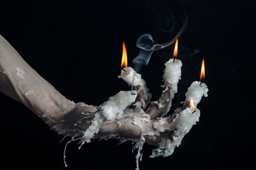 on the hand wearing a candle and dripping melted wax studio
