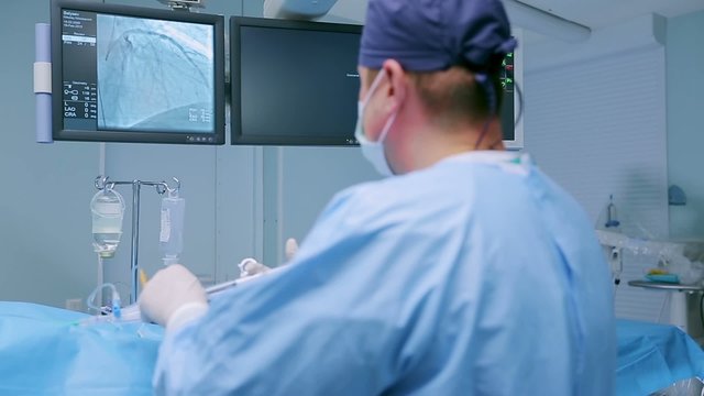 Surgeon controls the operation via monitor