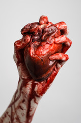 terrible bloody hand hold torn bleeding human heart isolated