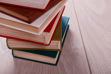 Stack of books on wooden background