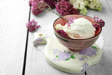Beautiful composition with tasty ice cream and lilac flowers