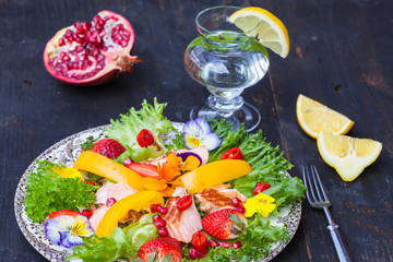 Fototapeta na wymiar Salad with smoked salmon and edible flower, top view